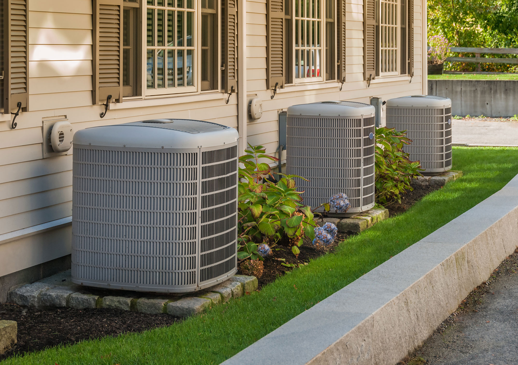 Residential air conditioning units outside house.