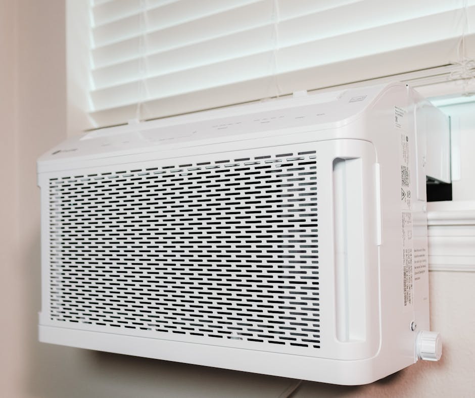 Window-mounted air conditioning unit installed in a home, illustrating a cooling solution for residential HVAC needs.